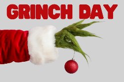 grinch hand holding Christmas ornament